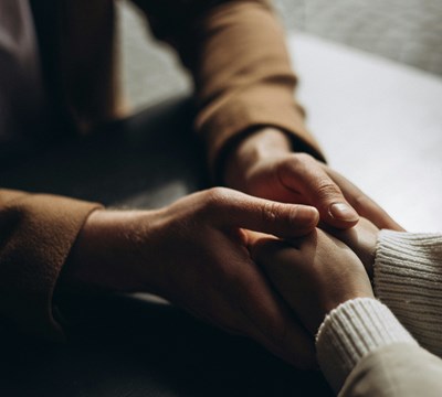 People holding hands showing sympathy and a tender-heart